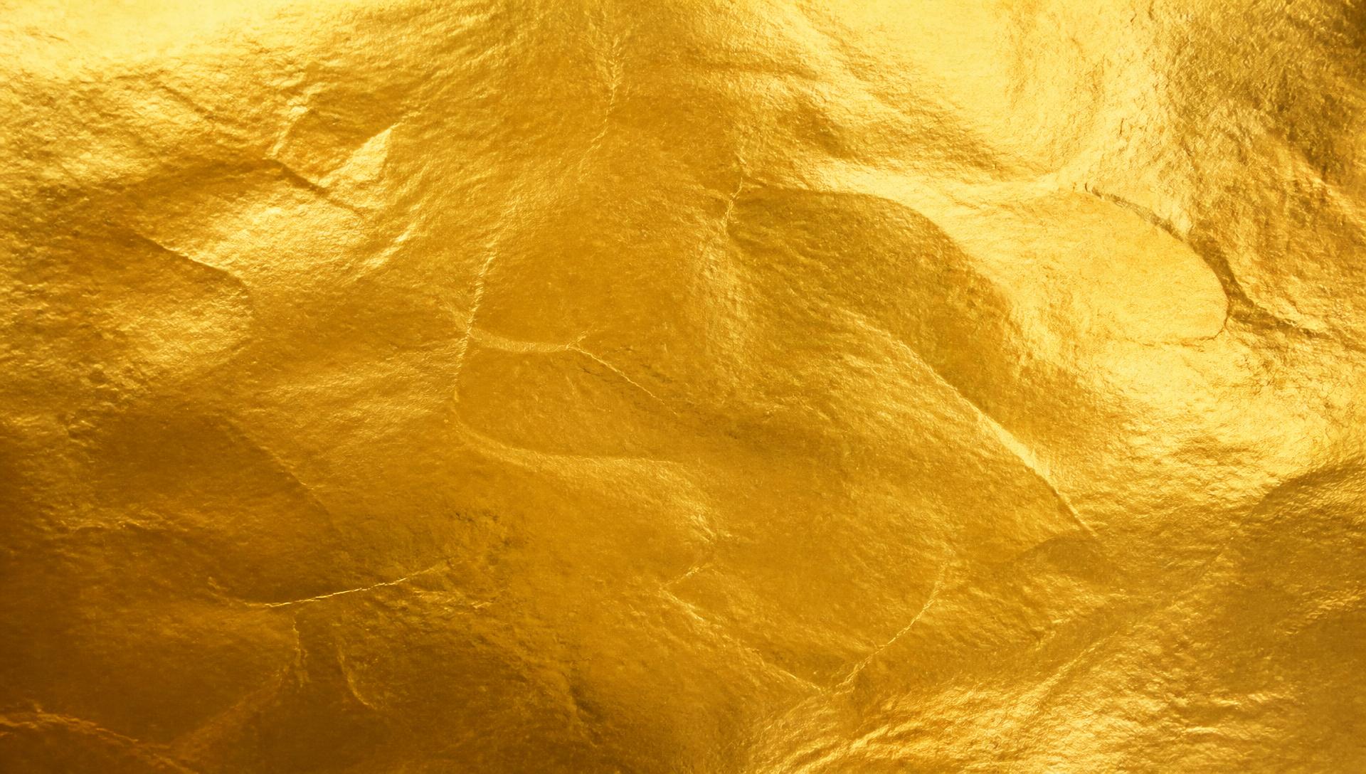Very slightly crinkled sheet of gold metallic paper
